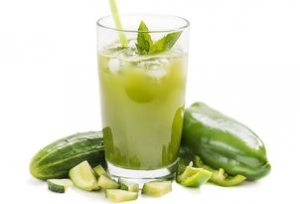 Glass of juice from fresh cucumbers with pepper